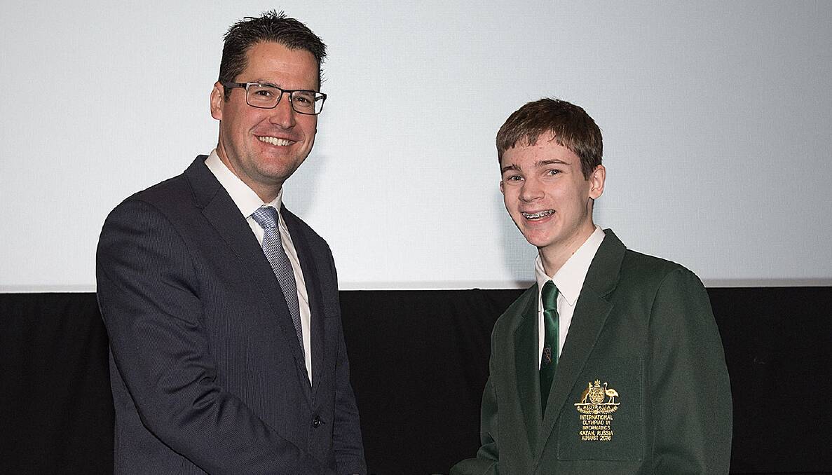 Declan McDonnell (right) was congratulated by Senator for the ACT Zed Seselja when he was presented his Australian blazer ahead of next month's Informatics Olympiad in Russia. It will be Declan's second time at the event. 