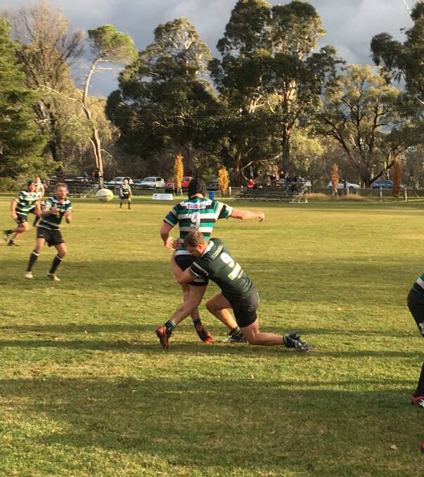 SCRUM: Young's Mick Stallard tackling his opposite number after a scrum at Hall on Saturday. The Yabbies went down to Hall in trying conditions, 49-nil. (sub)
