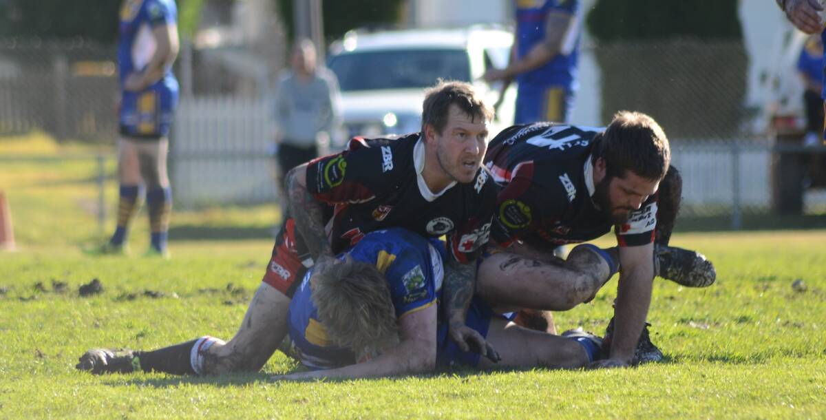 ACTION: Darcy Ballard and Brett Hardy take down a Condobolin Ram during Sunday's match at Cranfield Oval. Photo: Elouise Hawkey