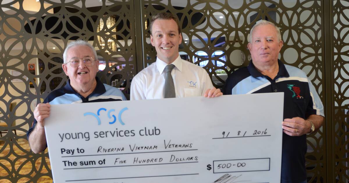 CHEQUE: Robert McGlynn and Terry Holmes were presented with a $500 cheque from Young Services Club supervisor, Sam Woods.