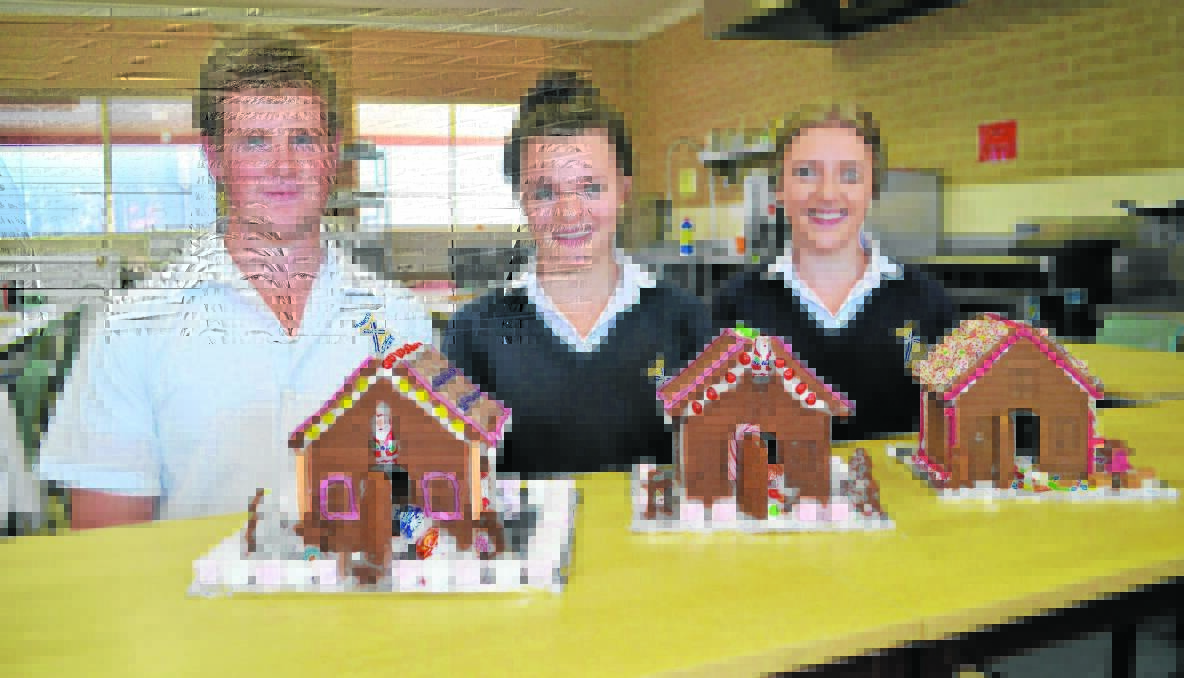 GINGERBREAD: Year 12 Hennessy Catholic College students, Hamish Stokehill, Rose Parker and Chloe Coffey show-off just three of the 18 gingerbread houses they and their fellow classmates have made recently.