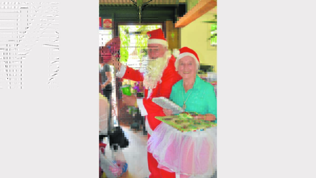 SANTA: Ted Webber and Beryl Callaway took on the important role of Santa and his little helper at the Probus Christmas party, handing out presents to all of the members.